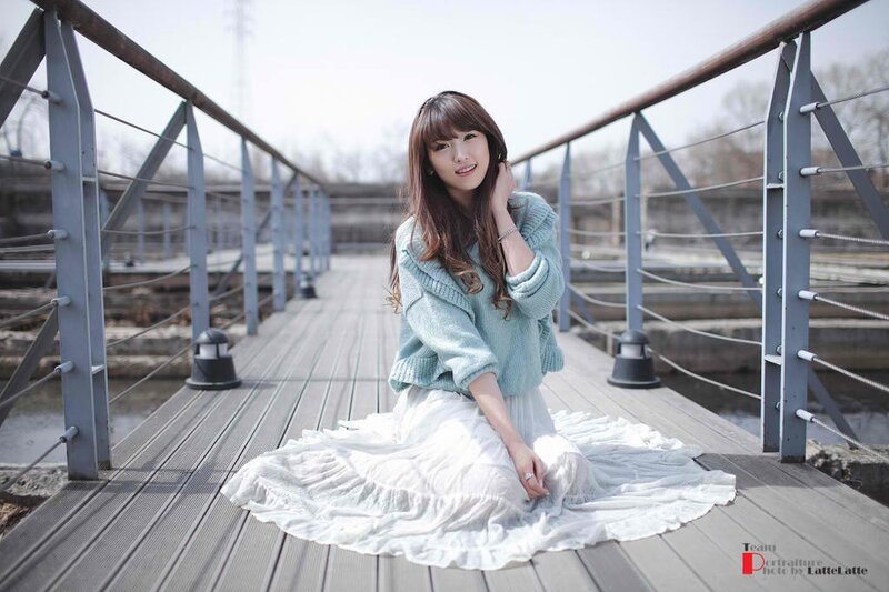 woman in sweater on a bridge