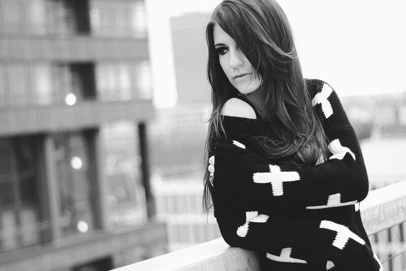 woman in sweater on balcony