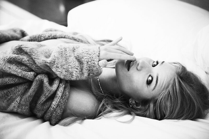 woman in sweater on bed