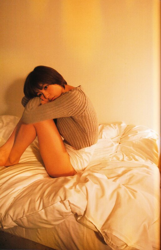 woman in sweater on bed