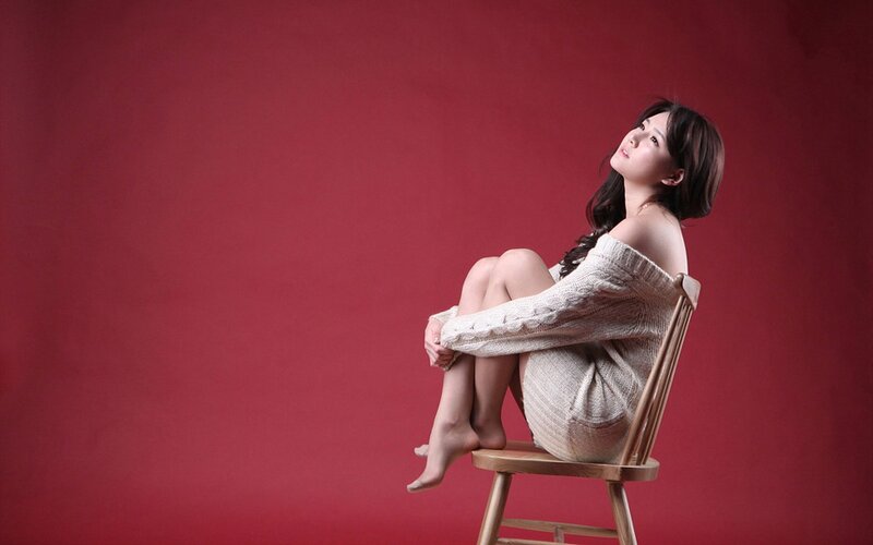 woman in sweater on chair