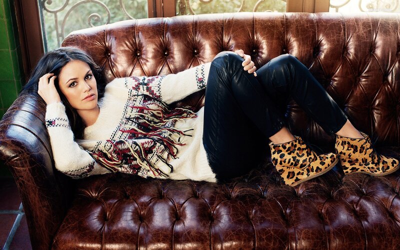 woman in sweater on leather couch