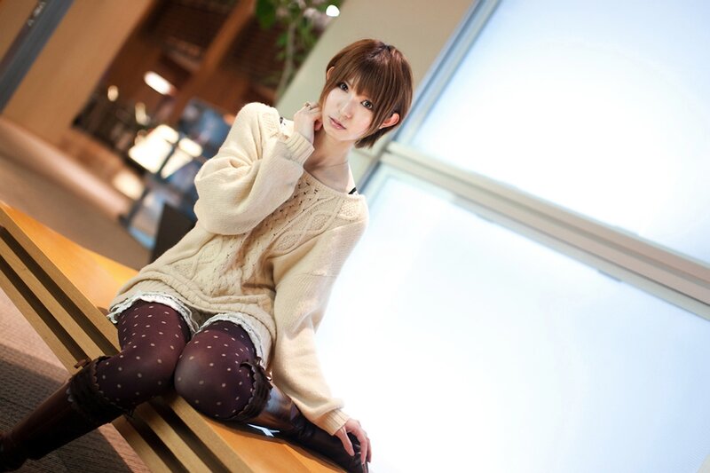 woman in sweater sitting on bench