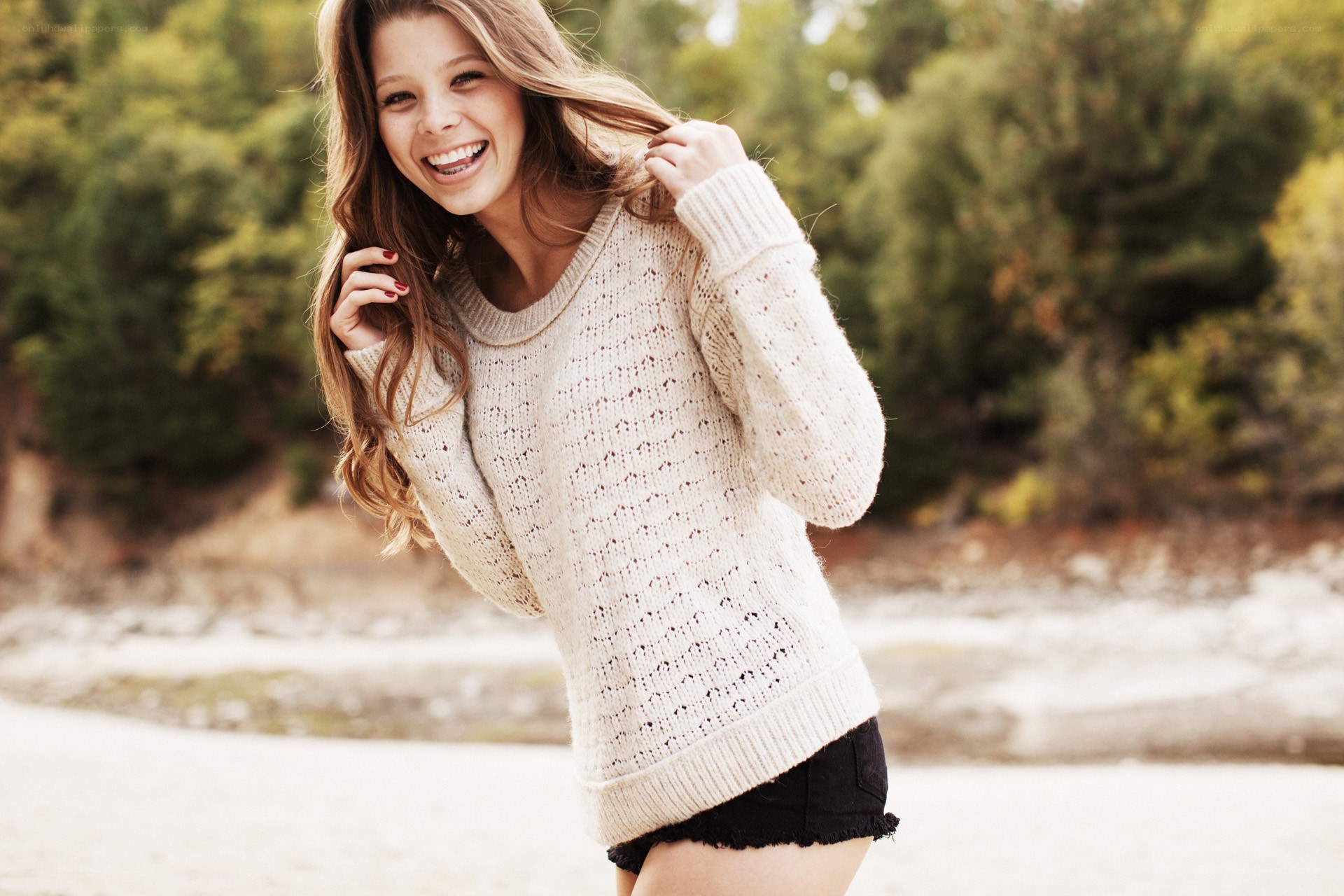 Woman in sweater smiling