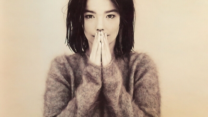 woman in sweater with hands clasped