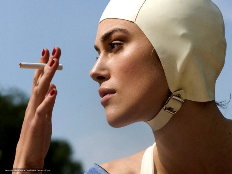 woman in swim cap smoking