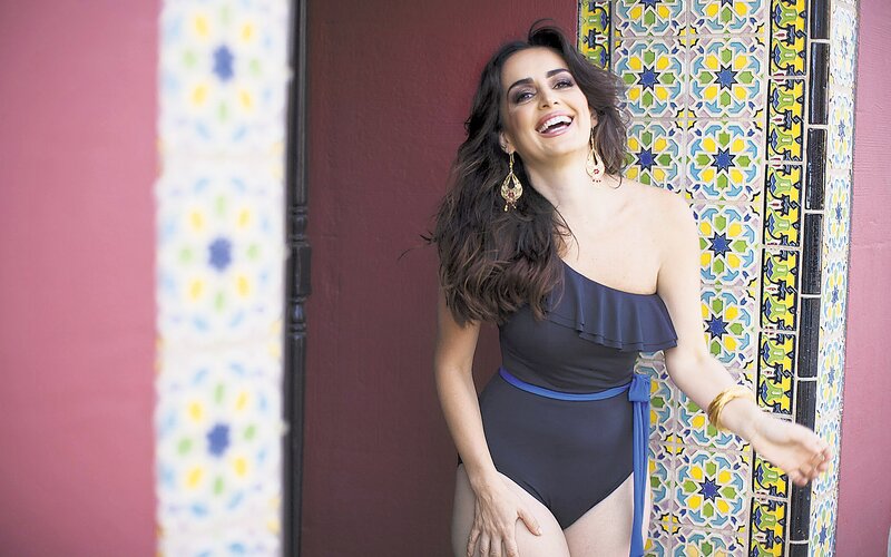 woman in swimsuit by tiled wall
