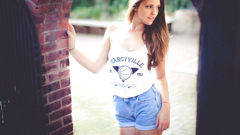 woman in tank top and denim shorts