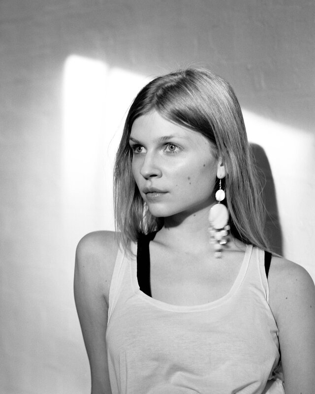woman in tank top with earrings