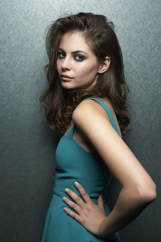 woman in teal dress posing