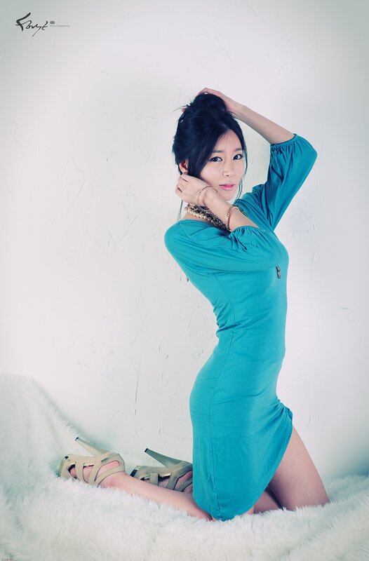 woman in teal dress posing