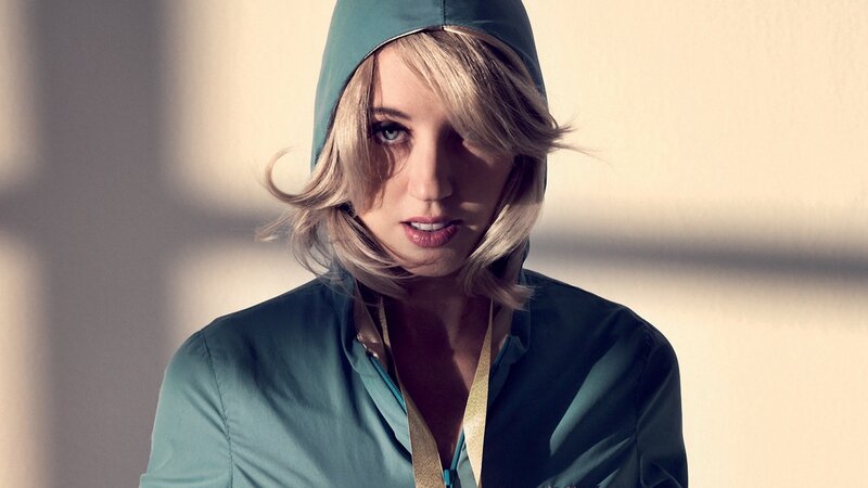 woman in teal hooded jacket