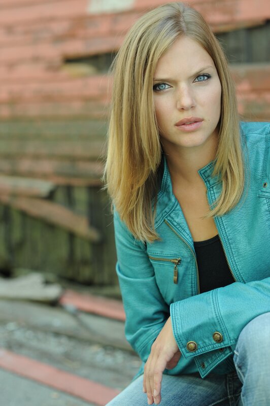 Woman in Teal Jacket — Serious