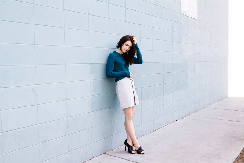 woman in teal sweater leaning