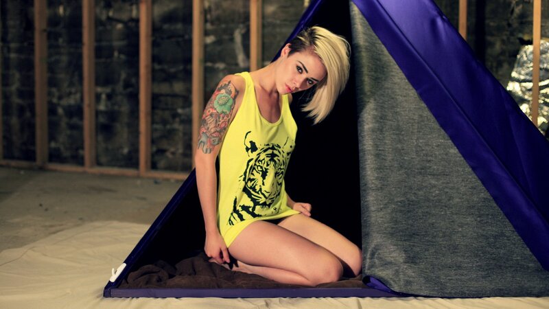 Woman in tent with tattoos
