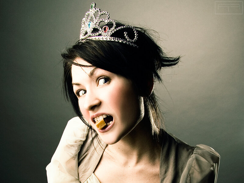 woman in tiara eating candy