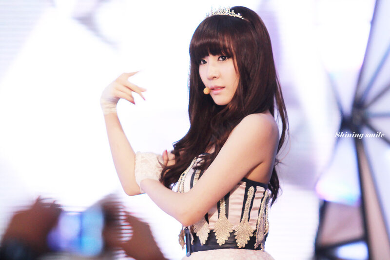woman in tiara performing on stage