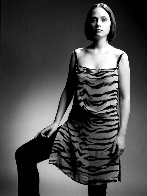 Woman in Tiger-print Dress — Black, Dramatic, Photograph