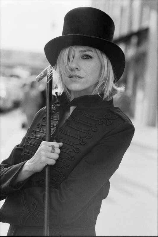 woman in top hat holding cane