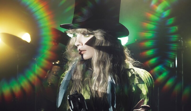 woman in top hat with colorful lights