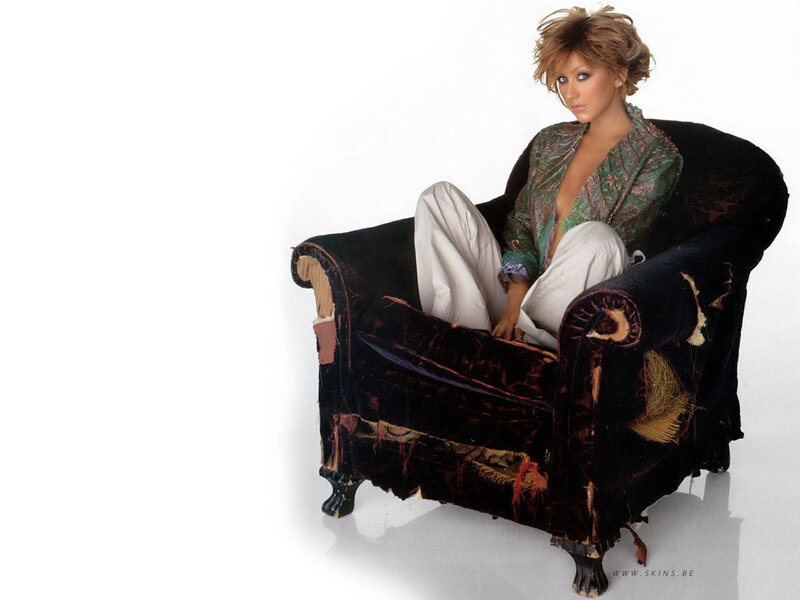 woman in torn armchair