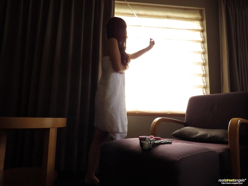 woman in towel by window
