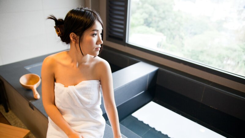 woman in towel by window