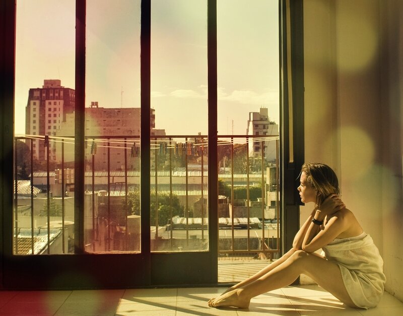 woman in towel by window