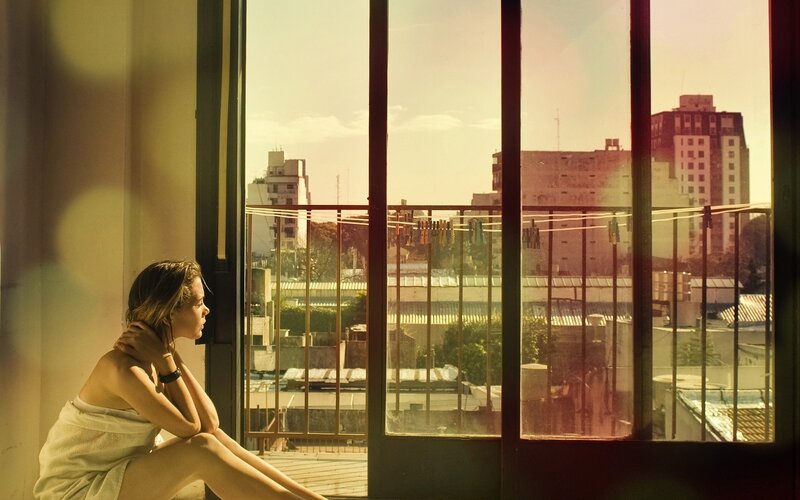 woman in towel by window