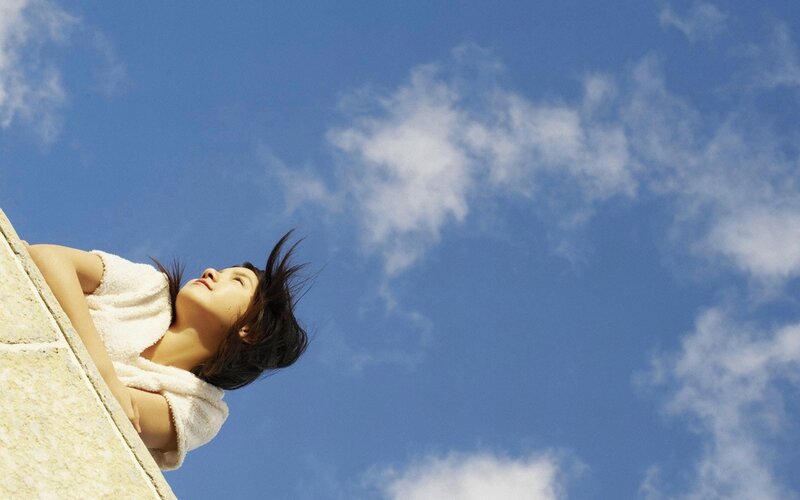woman in towel under blue sky
