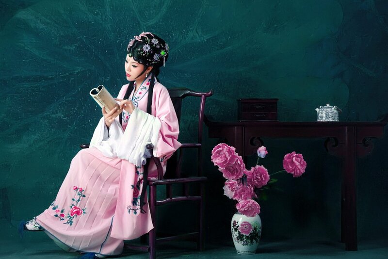 Woman in traditional costume reading