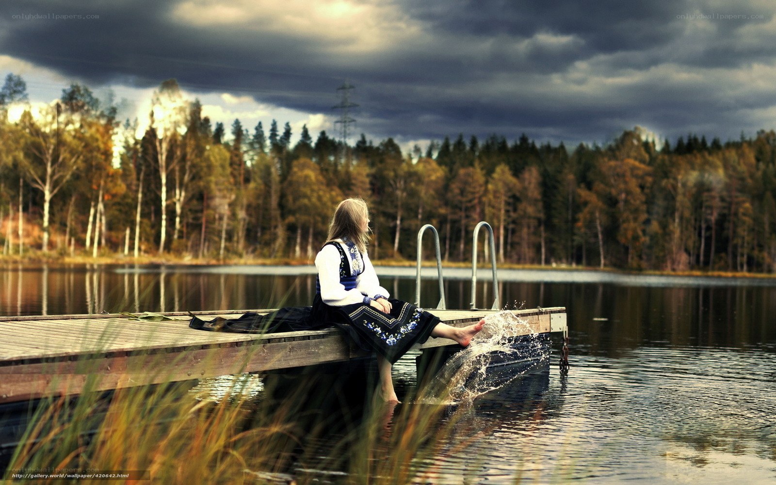 Woman in traditional dress by lake