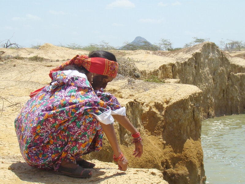 Woman in traditional dress by the water