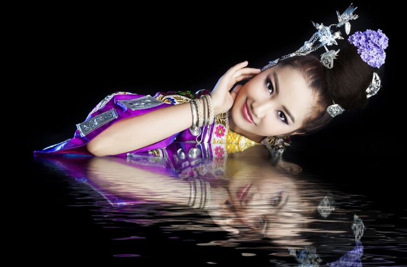 woman in traditional dress by water