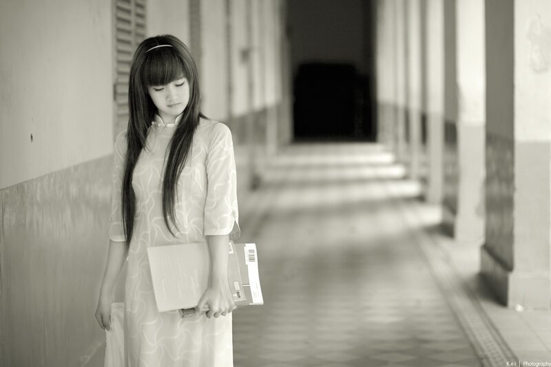 woman in traditional dress holding books