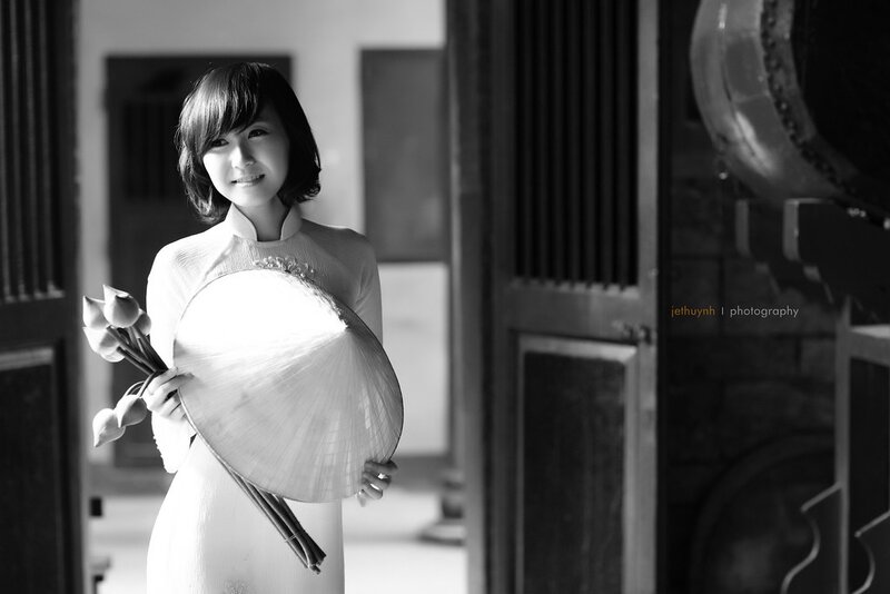 woman in traditional dress holding fan