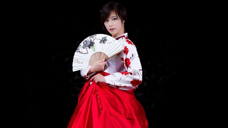 woman in traditional dress holding fan