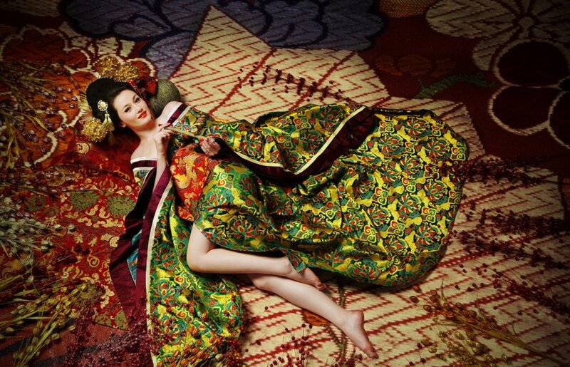 Woman in traditional dress lying on carpet