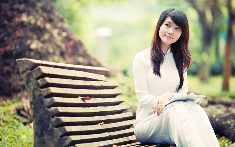 woman in traditional dress sitting on bench