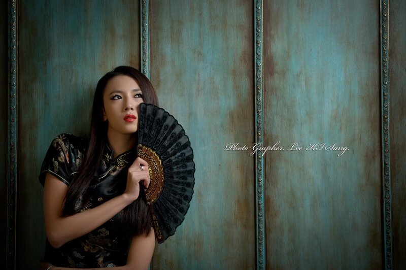 woman in traditional dress with fan