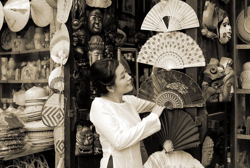 woman in traditional dress with fans