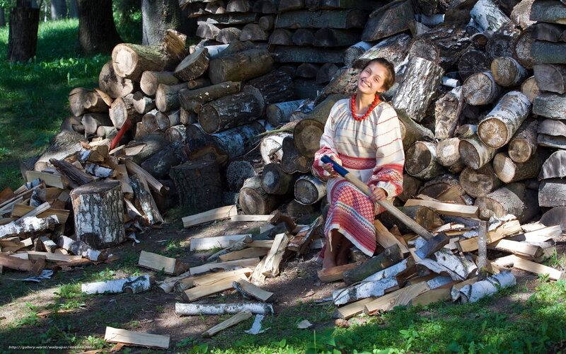 Woman in traditional dress with firewood