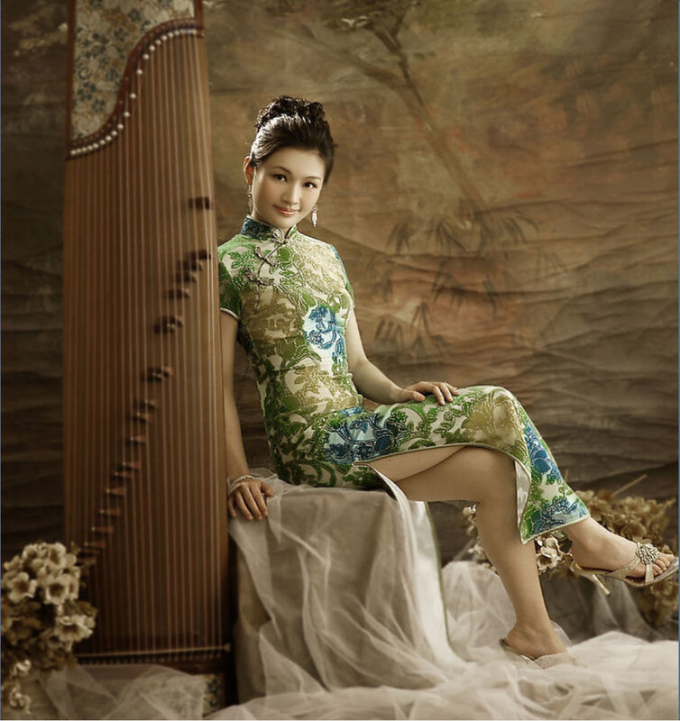 Woman in traditional dress with guzheng