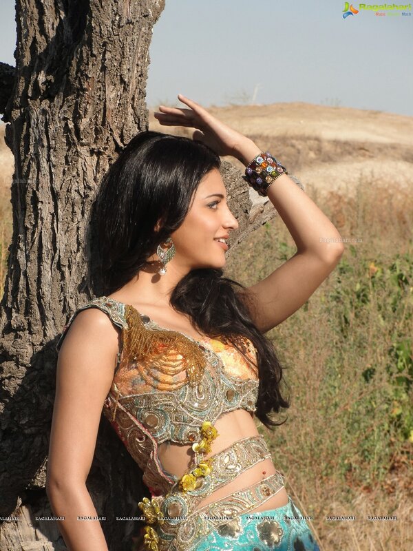 woman in traditional outfit by tree