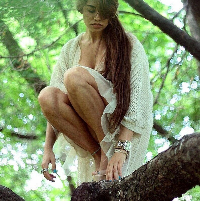 woman in tree wearing white dress