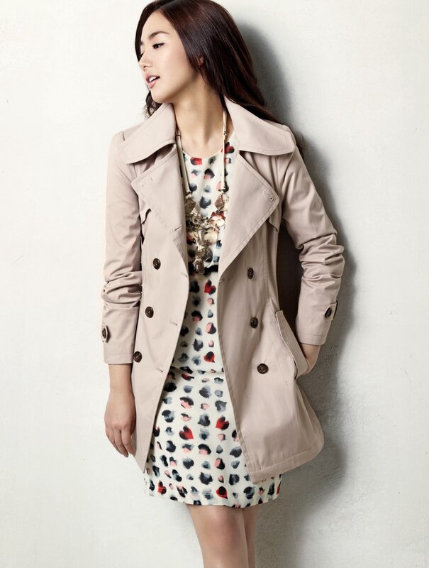 Woman in trench coat and dress