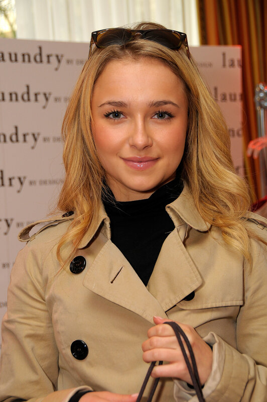 woman in trench coat at event