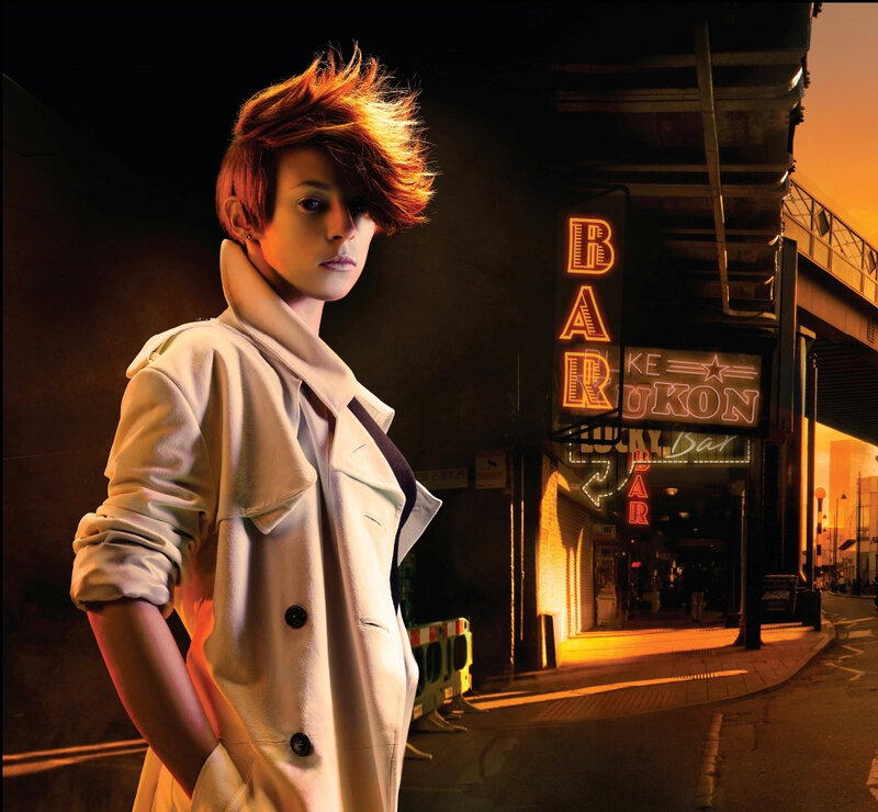 woman in trench coat at night