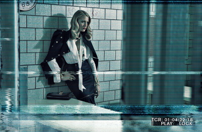 woman in trench coat by brick wall