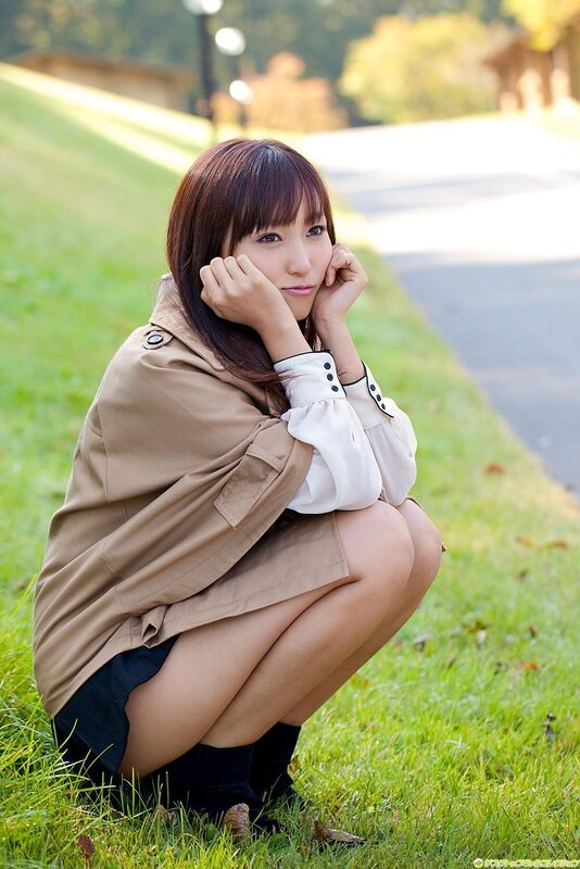 Woman in trench coat crouching